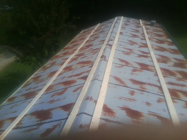 Rusted metal roof panels with new wood purlins before replacement — Storm Damage Roof Repair in Union Bridge by Roofing Brothers