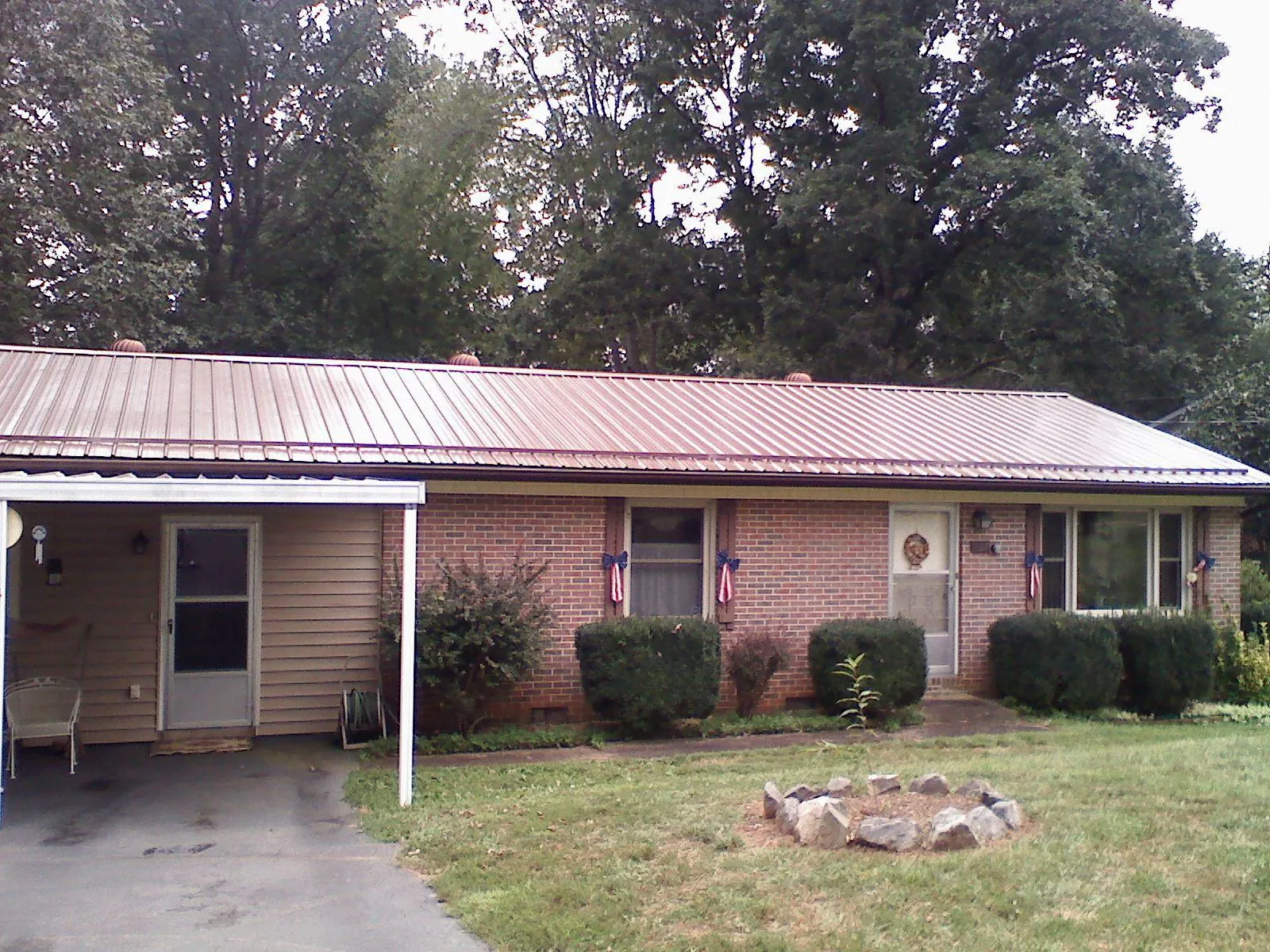 Bronze metal roof and carport on a brick ranch home — Roof Repair work by our crew in Union Bridge
