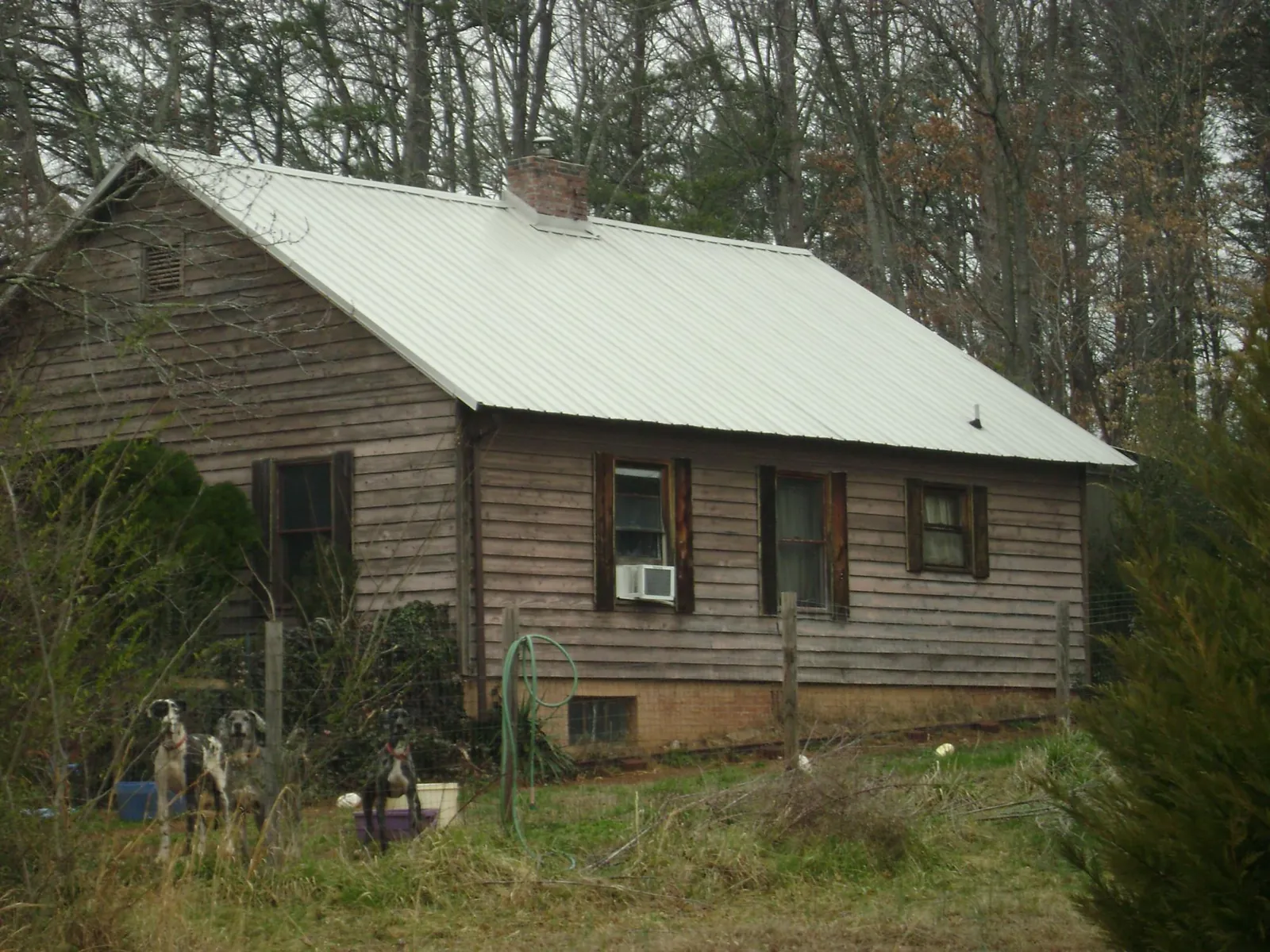 White metal roof on an old wood sided farmhouse, from a Metal Roof Installation job in Union Bridge